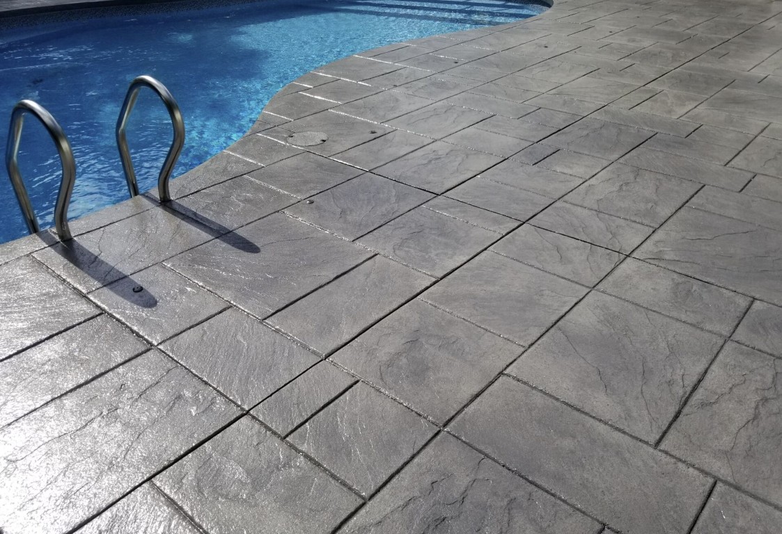 Decorative stamped concrete pool deck in DeKalb, Illinois